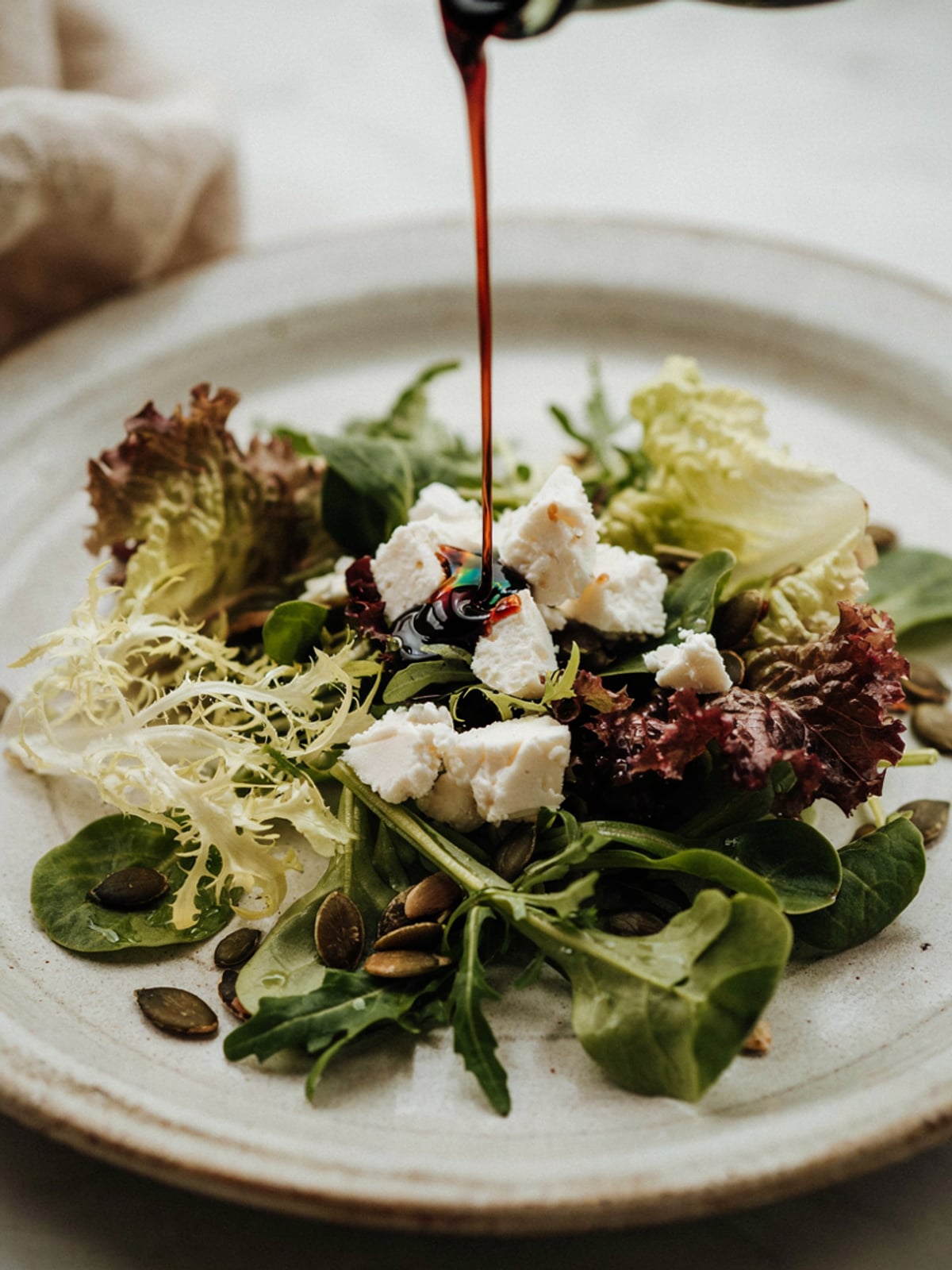 Ensalada de queso de cabra con aceite de calabaza